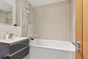 The super family bathroom has a bath with shower overhead.