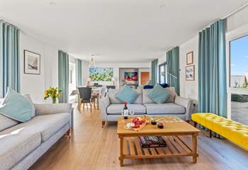 The open plan living space is beautifully furnished in pastel shades. 