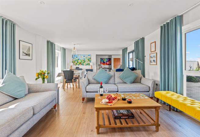 The open plan living space is beautifully furnished in pastel shades. 