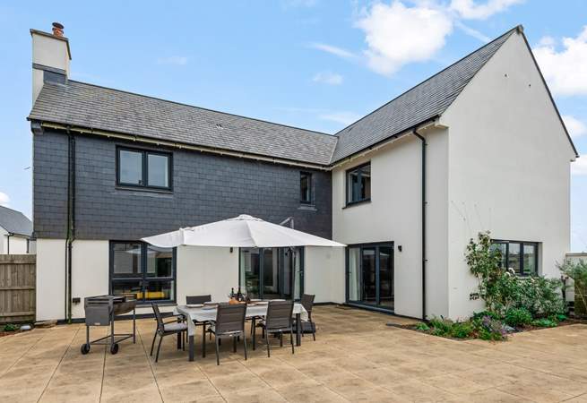 The spacious patio is the perfect spot for the family to come together and enjoy dining al fresco.