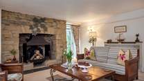 The characterful second sitting-room has an ornamental fireplace. 