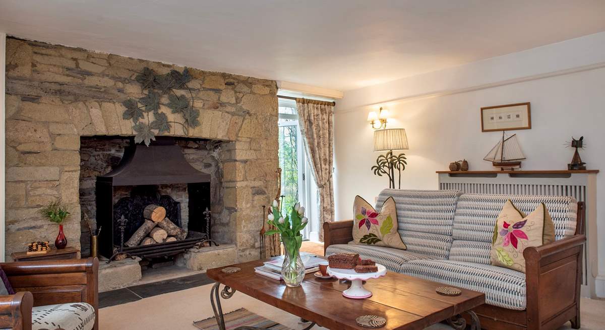 The characterful second sitting-room has an ornamental fireplace. 