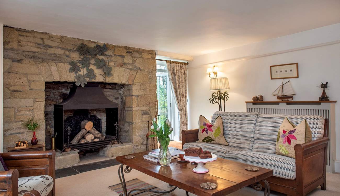 The characterful second sitting-room has an ornamental fireplace. 