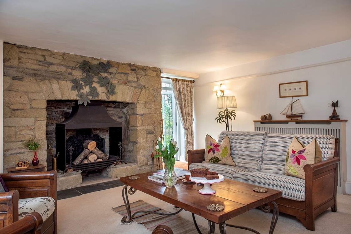 The characterful second sitting-room has an ornamental fireplace.