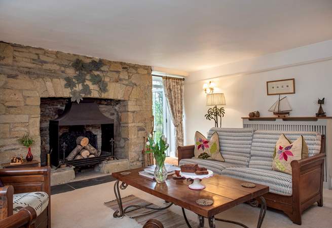 The characterful second sitting-room has an ornamental fireplace. 