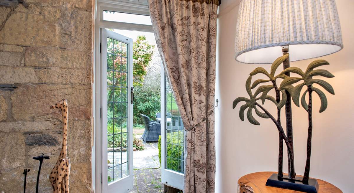 The patio doors lead to the terrace and beautiful gardens. 