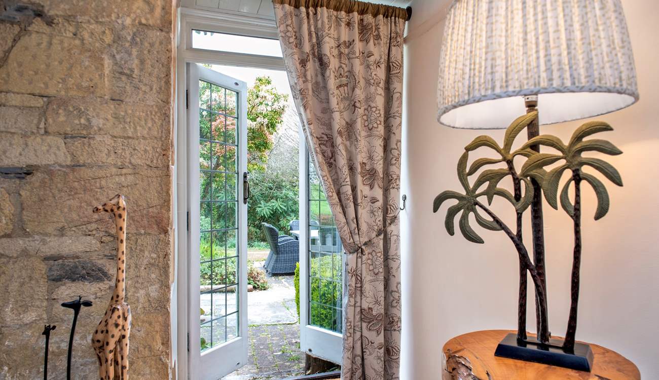The patio doors lead to the terrace and beautiful gardens. 