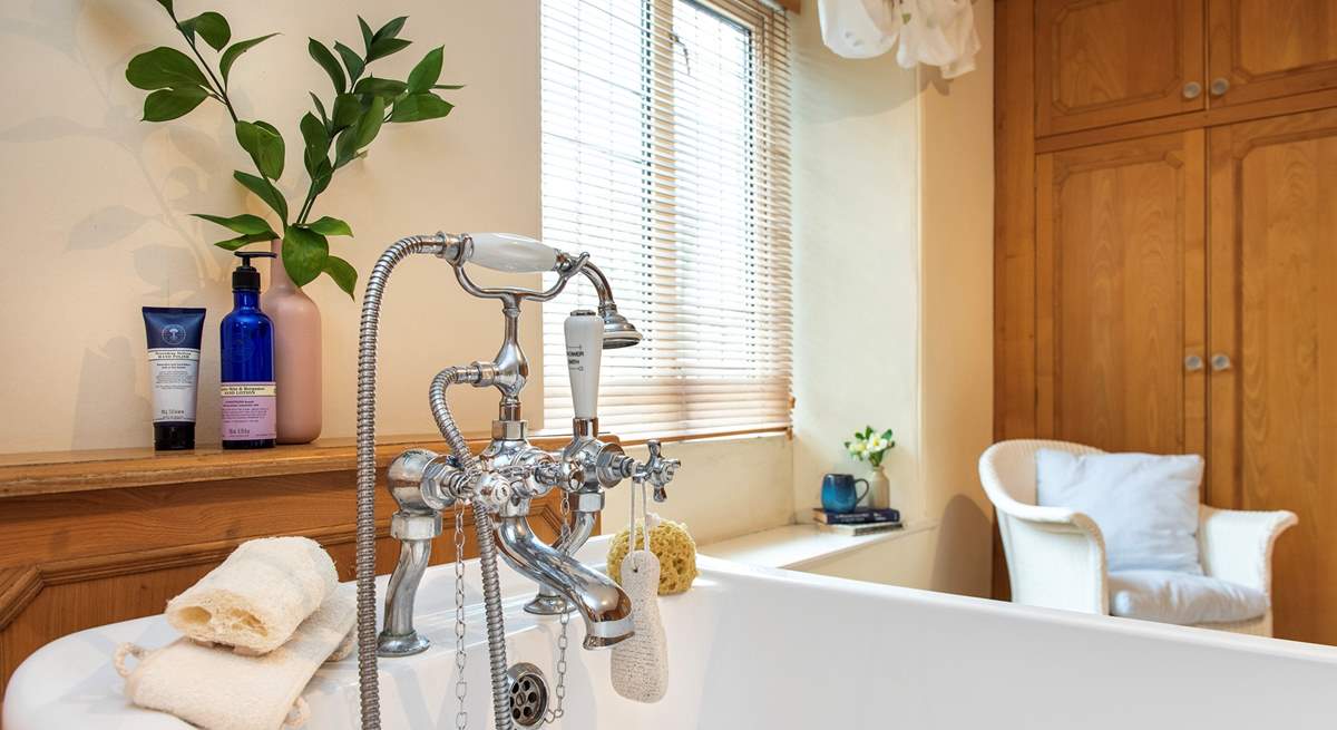 The family bathroom has a bath with hand shower attachment.