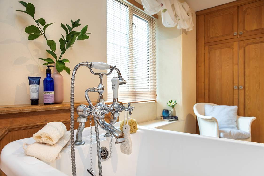 The family bathroom has a bath with hand shower attachment.