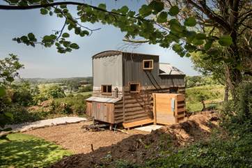 The outdoor shower is situated behind the hideaway.