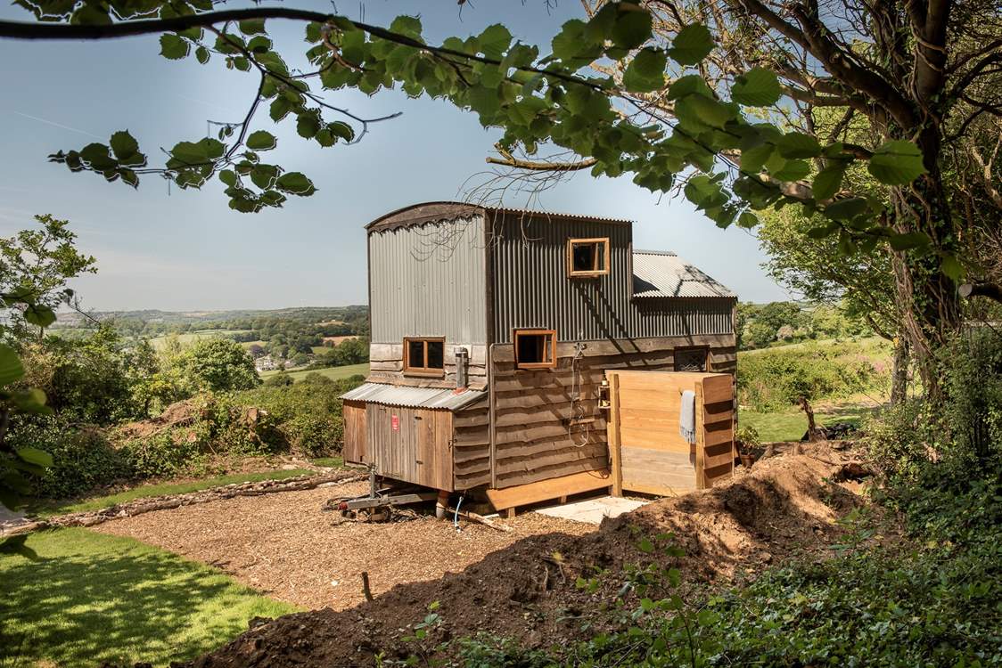 The outdoor shower is situated behind the hideaway.