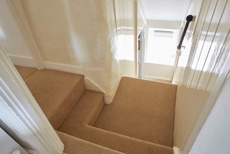 The cottage staircase with two steps up from the hallway to each of the bedrooms.