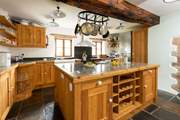 The kitchen looks out to the back garden and beyond and is fully equipped.