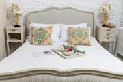The bedroom has a lovely French chic theme in muted tones.