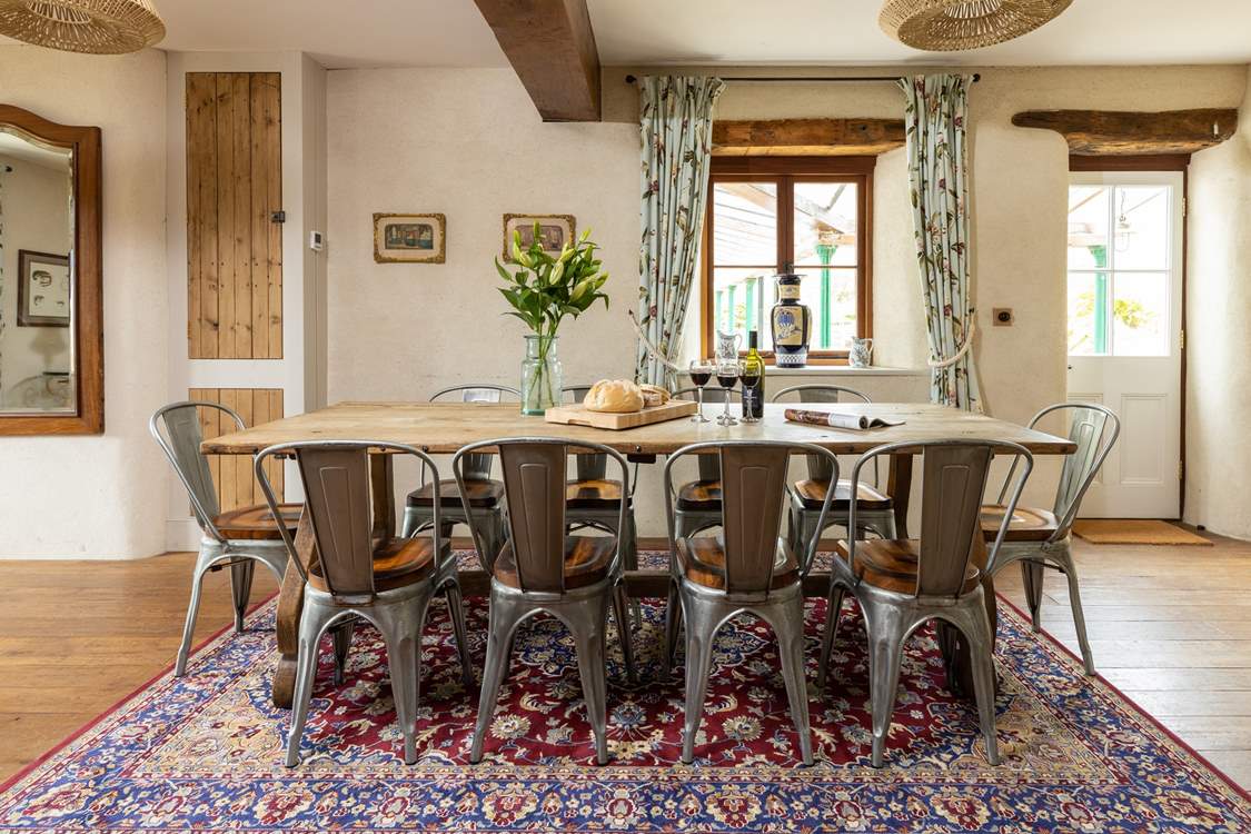 Whether you're eating or planning a day out, this table offers the perfect sitting spot. The door to the right of the table gives to access to the covered patio area and glorious back garden.