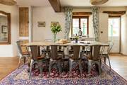 Whether you're eating or planning a day out, this table offers the perfect sitting spot. The door to the right of the table gives to access to the covered patio area and glorious back garden.
