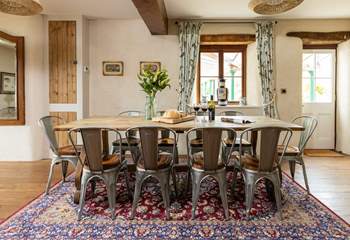 Whether you're eating or planning a day out, this table offers the perfect sitting spot. The door to the right of the table gives to access to the covered patio area and glorious back garden.