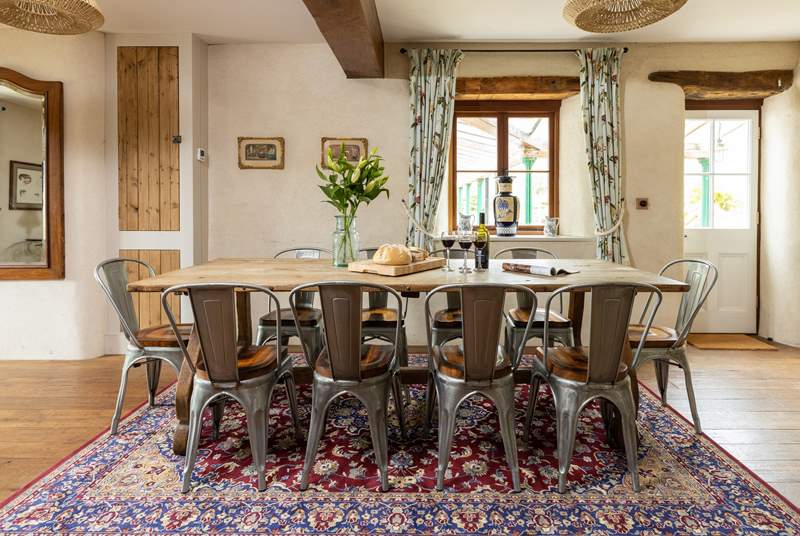 Whether you're eating or planning a day out, this table offers the perfect sitting spot. The door to the right of the table gives to access to the covered patio area and glorious back garden.