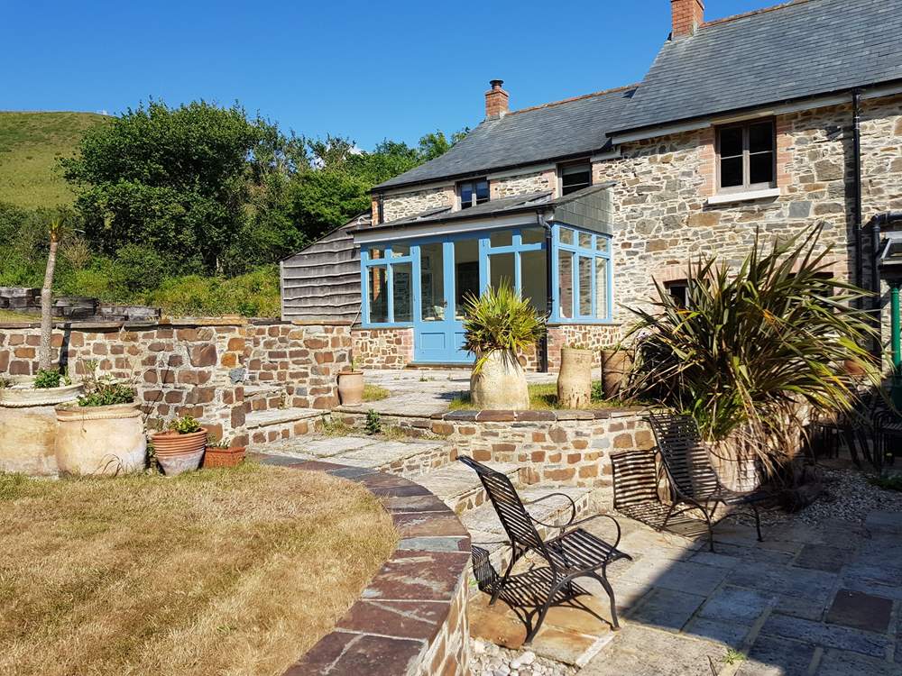 Strawberry Water Cottage's conservatory and patio area.