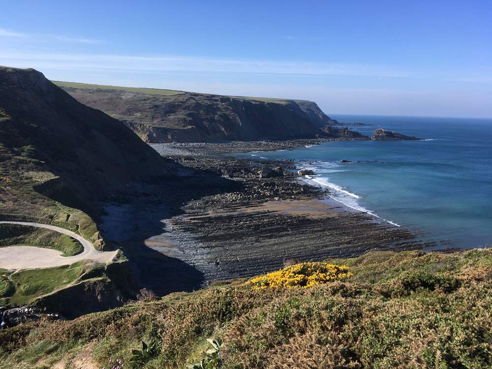 Welcombe Beach can be reached following the track/lane from the house. There is a car park which can be seen to the left of this picture.