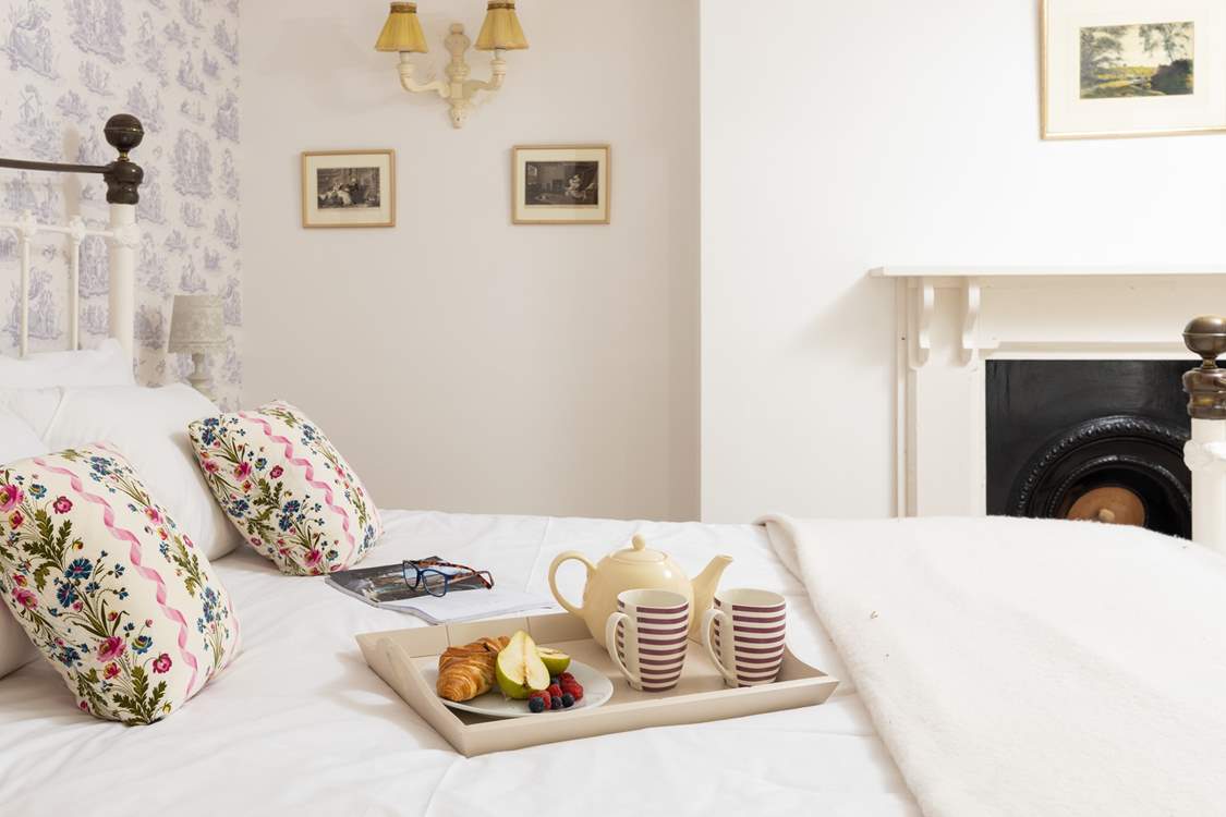 A room with a vintage French feel and lovely king-size bed.