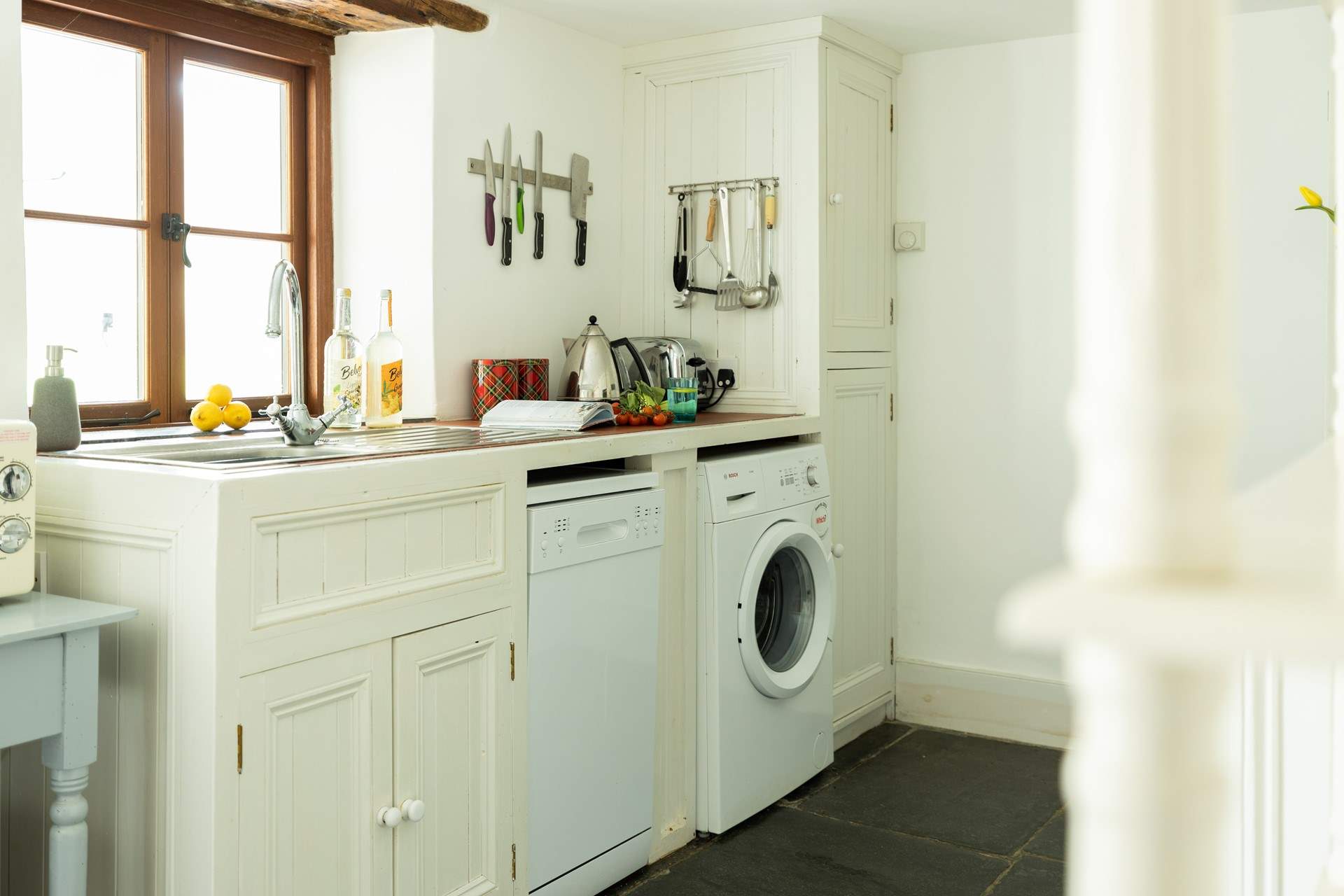 The hand crafted kitchen sits at the back of the cottage with views over the garden and is fully equipped.