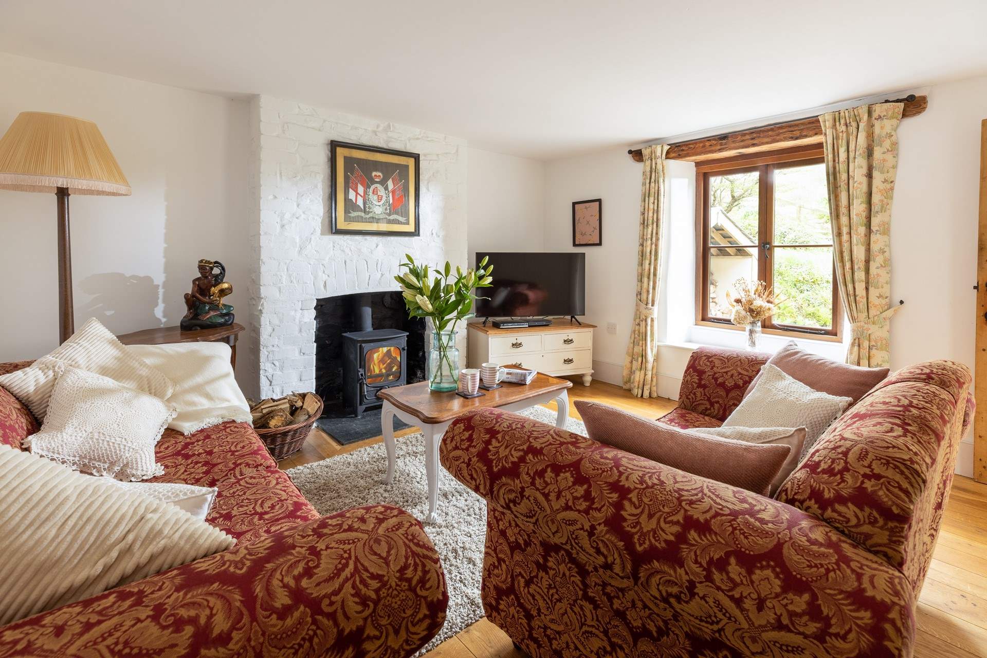 Enjoy this cosy inviting sitting-room with log-burner.