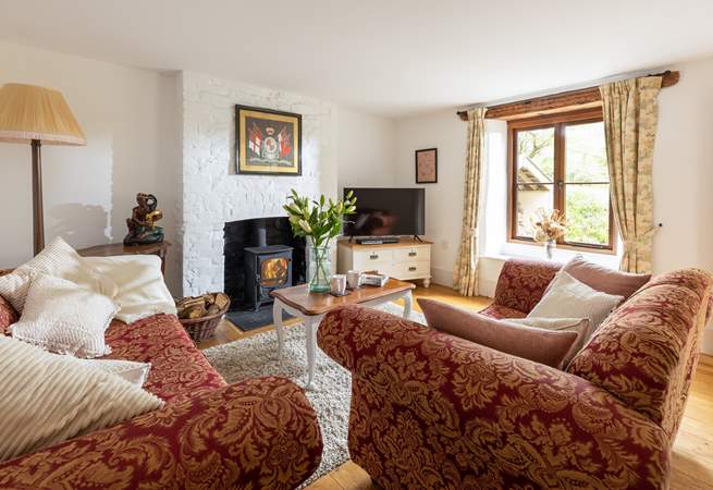 Enjoy this cosy inviting sitting-room with log-burner.