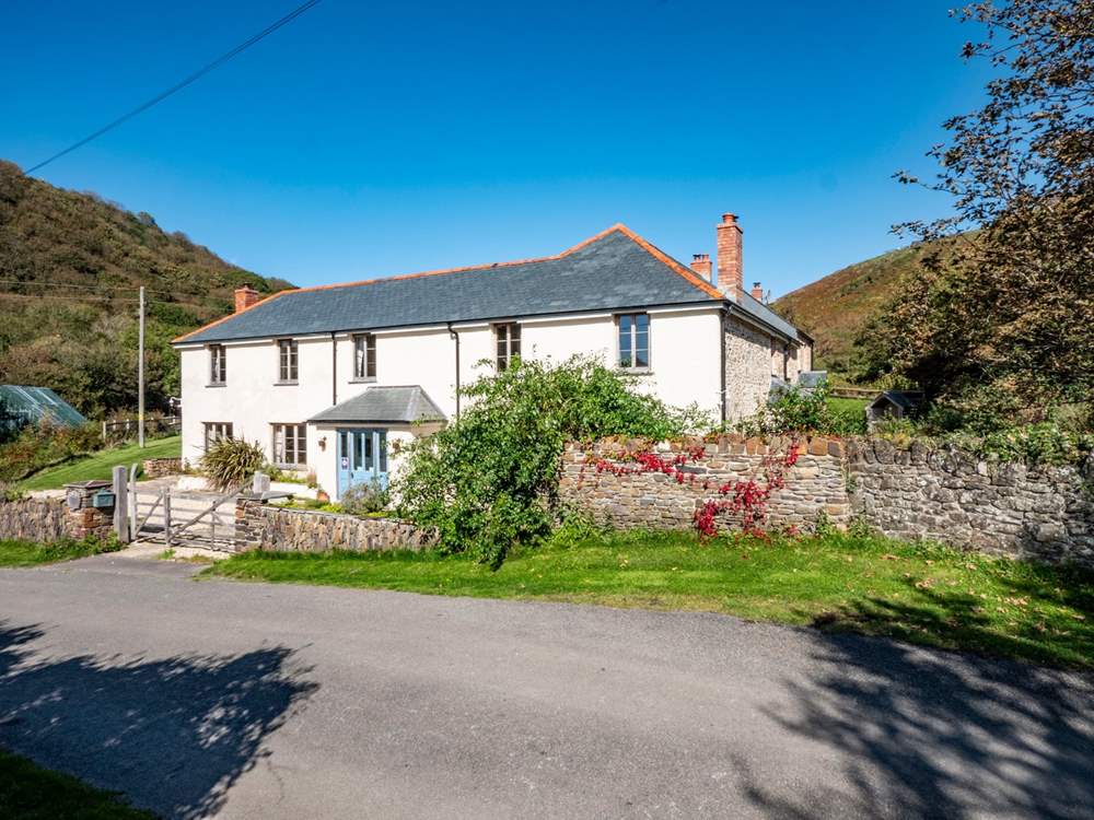 Park up opposite the house and walk across the lane following the path to the side of the house to find the front door.