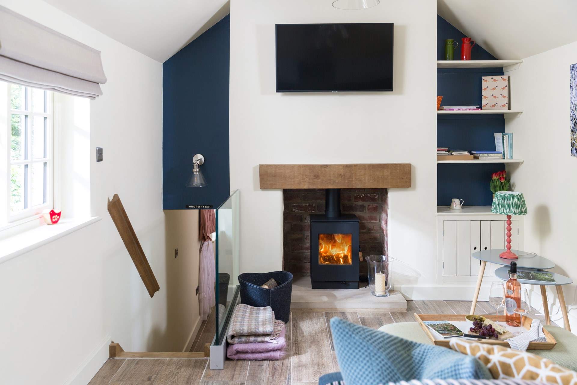 From here go down the bespoke stairs, custom made with storage drawers, to  the bedroom.