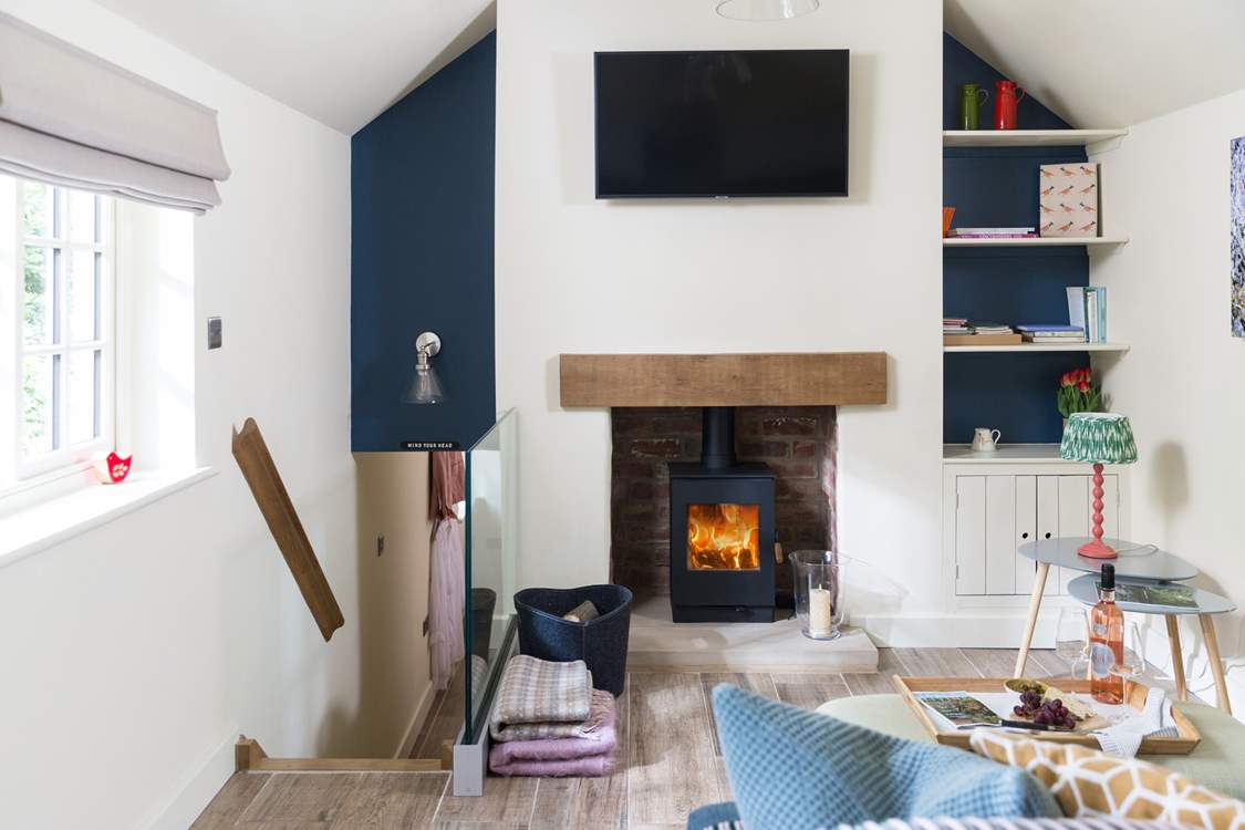 From here go down the bespoke stairs, custom made with storage drawers, to  the bedroom.