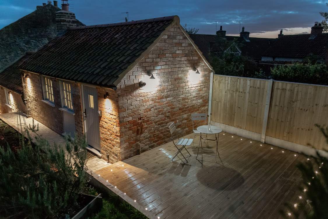 The patio is all lit up for night time, perfect for star gazing.