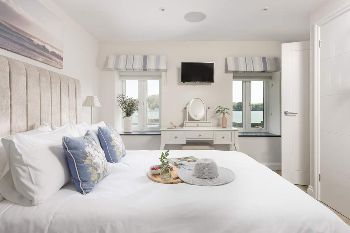 The main en suite bedroom has gorgeous river views and a king-size bed.