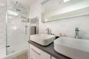 Twin sinks for that added bit of luxury and a separate enclosed shower.