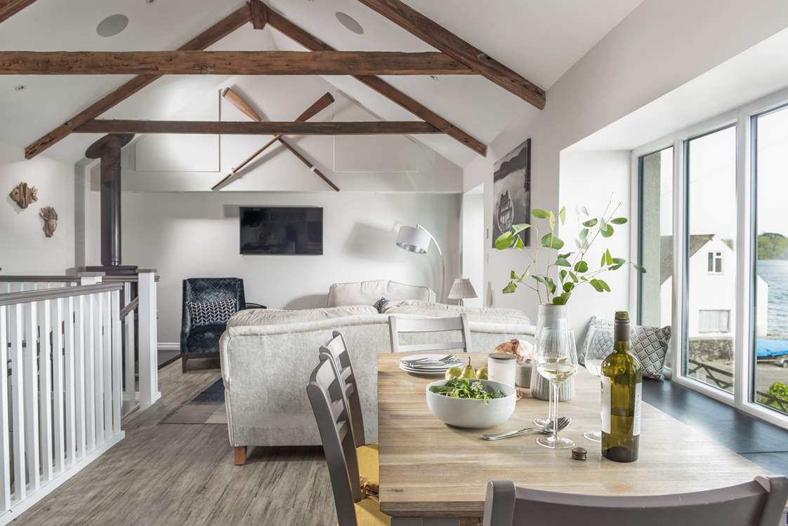 Step up into the living space and you'll find a spacious, open room with impressive vaulted ceiling and windows to make the most of the river views.