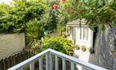 The small balcony from the master bedroom overlooks the pretty garden. - Thumbnail Image