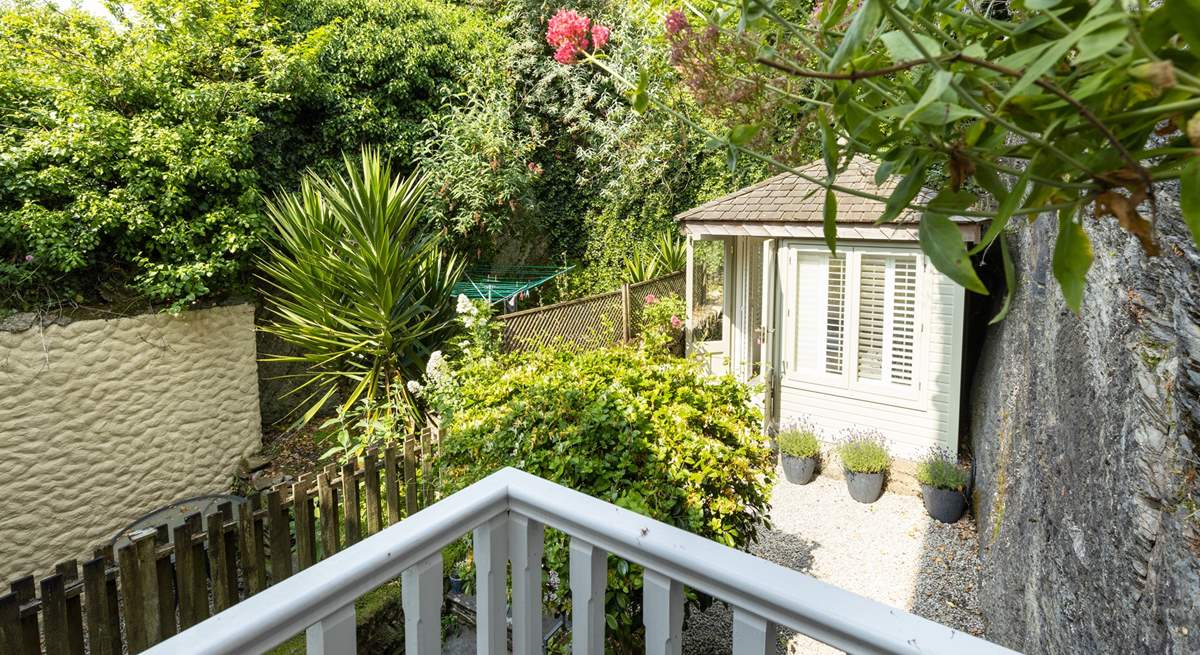 The small balcony from the master bedroom overlooks the pretty garden.