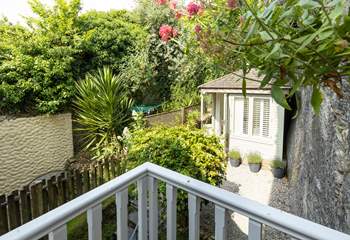 The small balcony from the master bedroom overlooks the pretty garden.