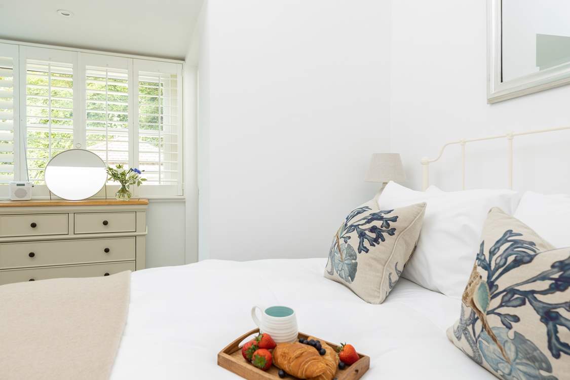 The gorgeous double bedroom has a comfy king-size bed.