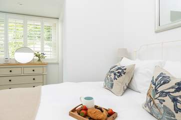 The gorgeous double bedroom has a comfy king-size bed.