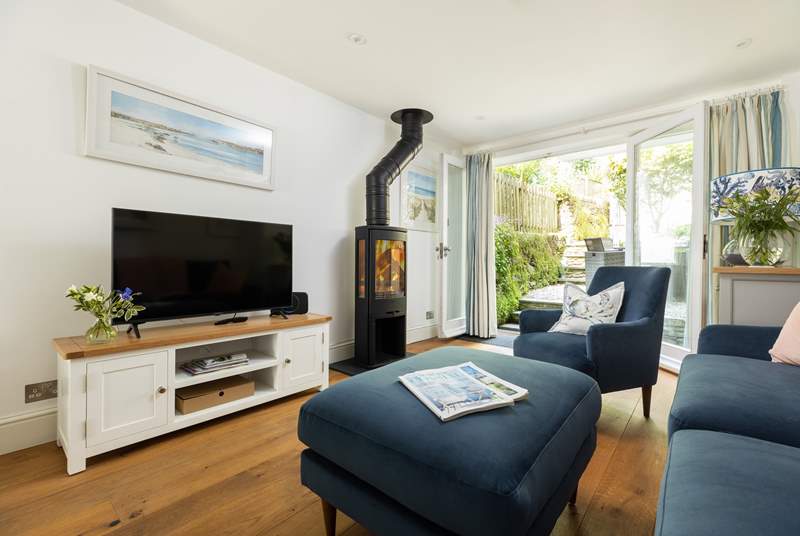 The gorgeous living space is ideal for all seasons with a wood-burner to keep you cosy in winter and French doors which open to let the breeze in to keep you cool in summer. 
