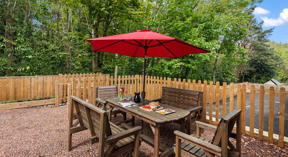 The delightful sitting-area with furniture and a barbecue is up a flight of steps.