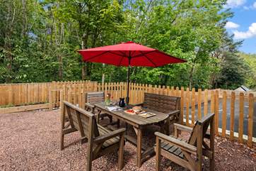 The delightful sitting-area with furniture and a barbecue is up a flight of steps.