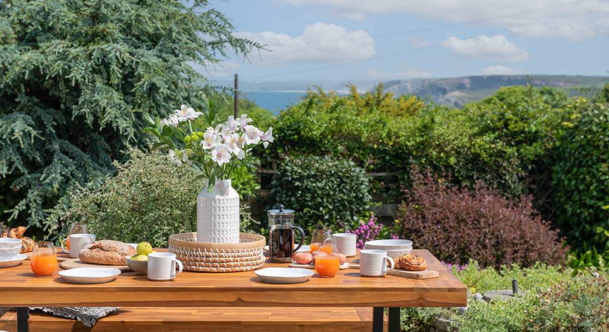 The elevated garden and stepped terrace is bursting with life and has a lovely view of the sea.