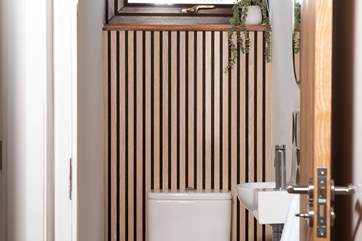 The cloakroom is located next to the family bathroom.
