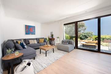 The sitting-room overlooking the garden is beautifully furnished.