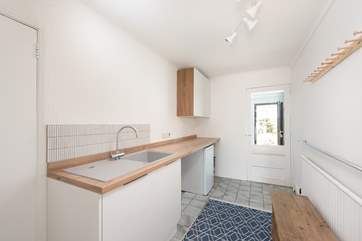The handy utility-room has a washing machine. This is a great space for all your doggy bits.