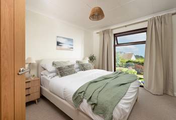 Delightful bedroom two has another king-size bed and overlooks the pretty garden.