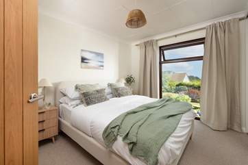 Delightful bedroom two has another king-size bed and overlooks the pretty garden.