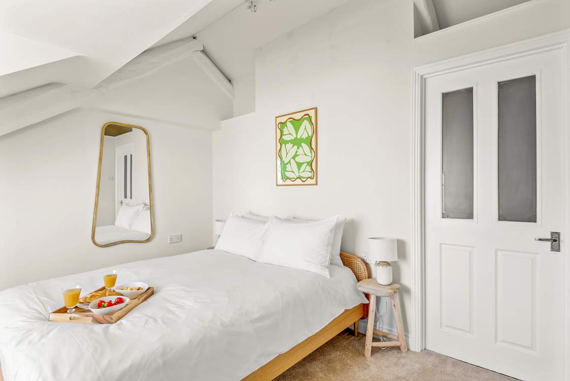 The bedroom is light and airy.